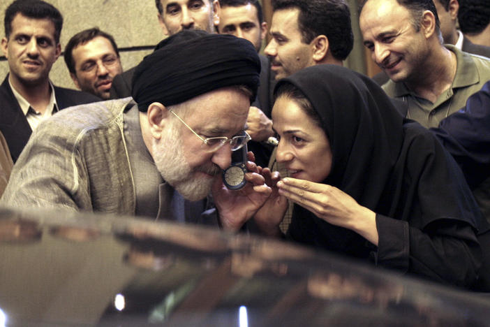 In this July 13, 2005, file photo, outgoing reformist Iranian President Mohammad Khatami talks on the phone with the mother of female journalist Masih Alinejad, right, after meeting with journalists in Tehran, Iran. Prosecutors in the U.S. alleged Tuesday, July 13, 2021, that Iran planned to kidnap Alinejad, famous for her campaign against the Islamic Republic's mandatory headscarf, or hijab, for women. Iran did not immediately comment on the allegation Wednesday, July 14, 2021. 