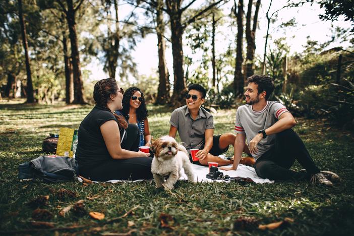 Group of people sitting in a grassy field