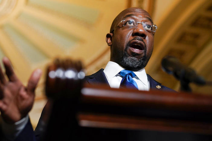 Sen. Raphael Warnock, D-Ga., speaks during a news conference after the weekly Democratic policy luncheon on Capitol Hill in Washington, Tuesday, Dec. 7, 2021. A bipartisan group of Georgia lawmakers is asking congressional budget writers to reject the Biden administration's plan to close a training facility for military pilots.