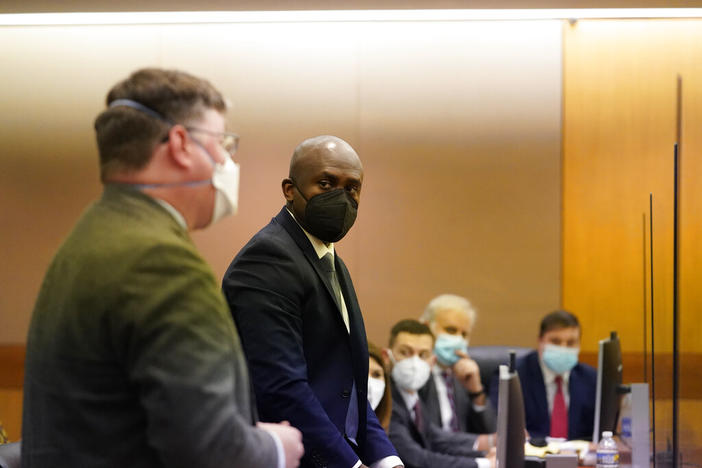 Attorney Uzoma Nkwonta, center, prepares to speak in a Fulton County Courthouse on Friday, Nov. 18, 2022, in Atlanta. A lawsuit was filed by the Democratic Party of Georgia, Democratic Senatorial Campaign Committee and the Warnock campaign that challenges guidance by Republican Secretary of State Brad Raffensperger, saying that it would be illegal to hold early voting on Saturday, Nov. 26, the day after a state holiday.