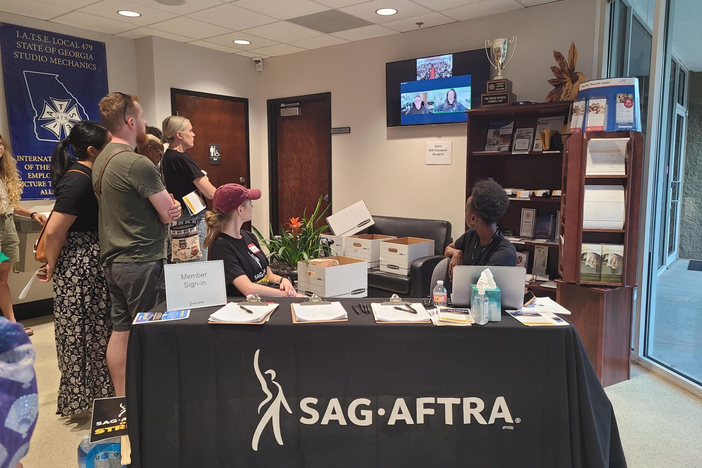 Supporters stand in the lobby by the members to sign in table to hear remarks from SAG AFTRA President Fran Drescher who joined the Atlanta rally via Zoom.