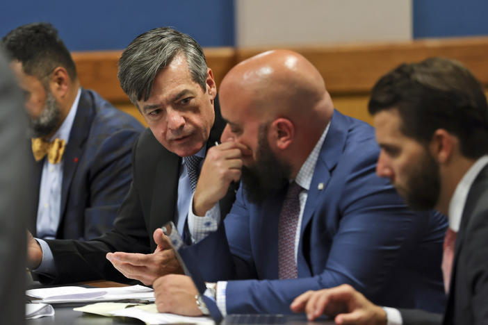 Kenneth Chesebro, left, confers with is lawyer Scott Grubman, as Judge Scott MacAfee presides as the lawyers of Sidney Powell and Chesebro appear during a motions hearing in the election subversion case Tuesday, Oct. 10, 2023, in Atlanta. Powell and Chesebro, indicted in August along with Trump and others, are accused of participating in a wide-ranging scheme to illegally try to overturn the results of the 2020 presidential election, which Donald Trump, the Republican incumbent, had lost to Democrat Joe Bid