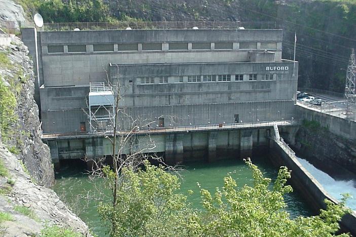 A large dam and power generation facility is shown.