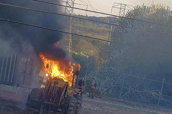 This image provided by the Atlanta Police Department shows construction equipment set on fire Saturday, March 4, 2023 by a group protesting the planned public safety training center, according to police. The trial was delayed Wednesday, Jan. 10, 2024, for the first defendant among dozens indicted last summer under Georgia's anti-racketeering law on allegations related to protests against a planned police and firefighter training facility near Atlanta. 