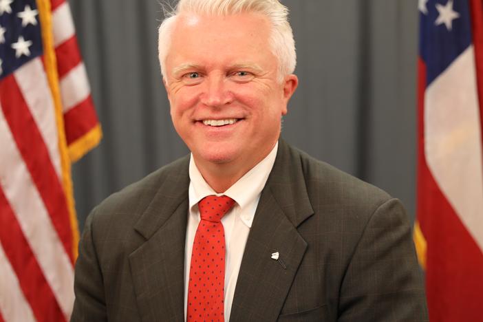 An official photo of Randy Robertson is shown.