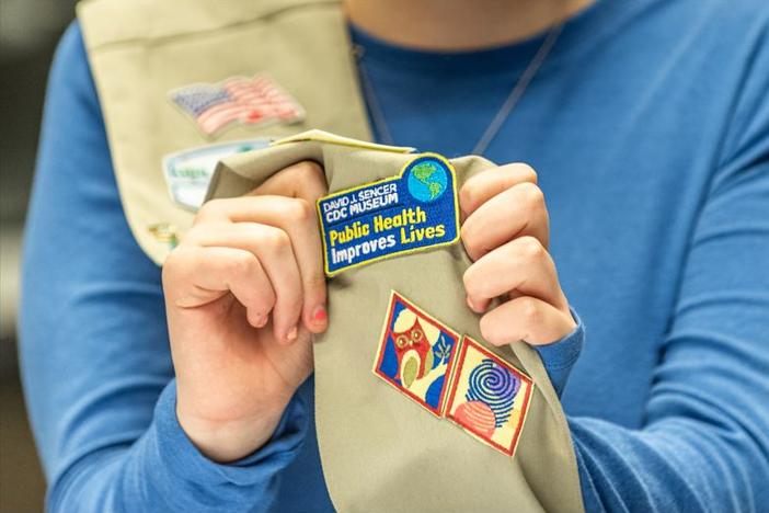 A public health patch swen on a Girl Scout sash
