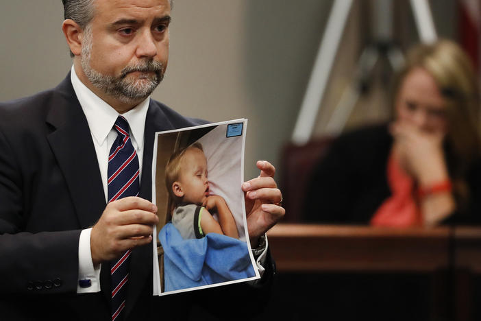 Defense attorney Maddox Kilgore holds a photo of Cooper Harris during the murder trial for his father, Justin Ross Harris, Oct. 31, 2016, in Brunswick, Ga. Georgia prison records show Harris was released from prison on Father's Day, Sunday, June 16, 2024, 10 years after his toddler died in a hot car, a case that made global headlines after prosecutors accused him of murder. 