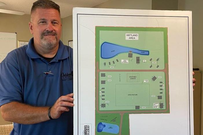 Randy Nichols hold up plans for a campus dedicated to people in drug and alcohol addiction recovery.