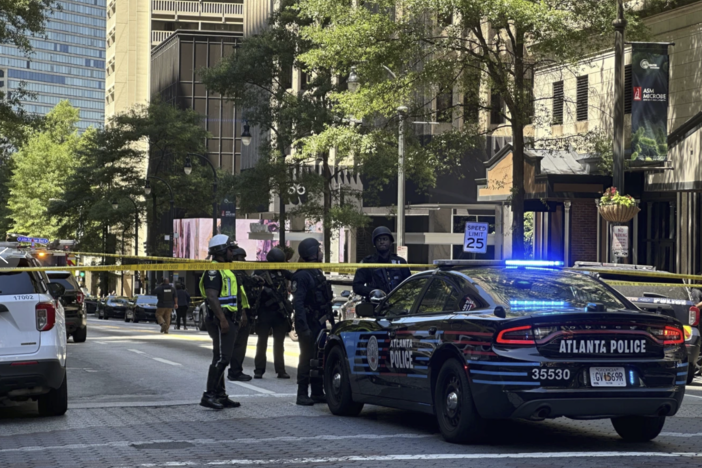 Police respond to the scene of a shooting outside the Peachtree Center complex, Tuesday, June 11, 2024, in downtown Atlanta.