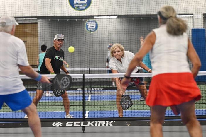 Tony Martinez, 71, left, and Joanna Crawford, 65, from Thomaston, Georgia, compete in mixed doubles on the second day of the United States Senior Pickleball Indoor National Championships on Saturday, July 13, 2024, at Rhythm and Rally Sports & Events in Macon, Georgia. United States Senior Pickleball hosted its inaugural indoor national championships this year, spanning three days and bringing hundreds of seniors to compete in Macon from across the country. KATIE TUCKER/THE TELEGRAPH