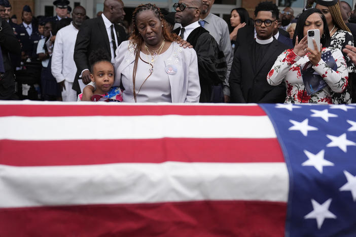 Chantemekki Fortson the mother of slain airman Roger Fortson, right, along with family watch Fortson's casket as they leave for a cemetery during his funeral at New Birth Missionary Baptist Church, on May 17, 2024, in Stonecrest, Ga. 