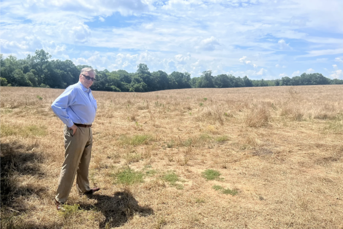 Ed Whitehouse, a consultant for a local company called Interstate Health Systems, stands on a plot of land in rural Butts County, Georgia. The company envisions replacing acres of farmland and trees with a new hospital. A recent change to Georgia law is giving the project a path forward. 