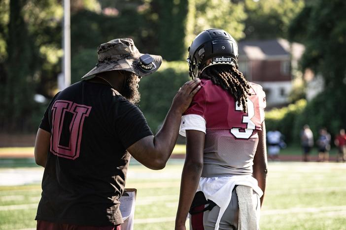 Utopian Academy head coach with a player