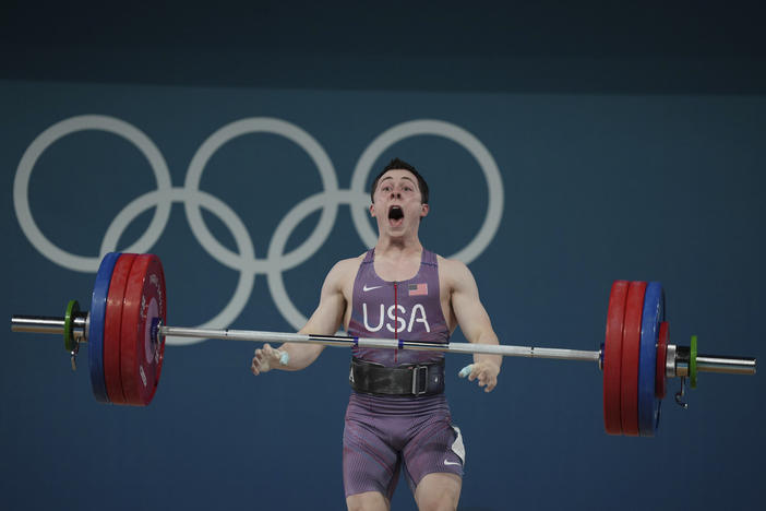 Hampton Morris of the United States reacts as he competes during the men's 61kg weightlifting event at the 2024 Summer Olympics, Wednesday, Aug. 7, 2024, in Paris, France. 