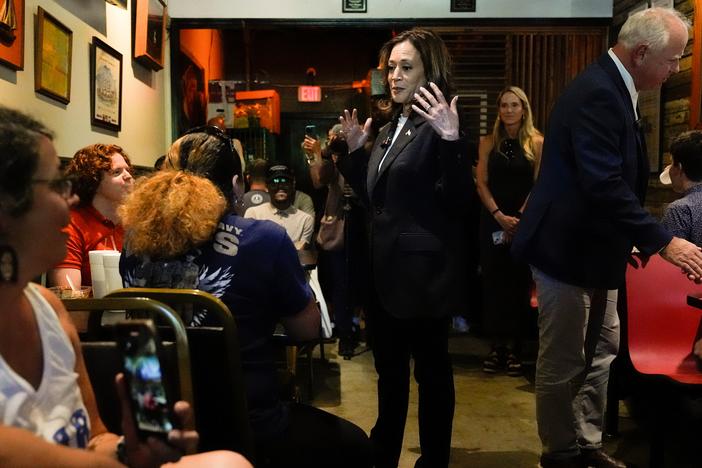 Democratic presidential nominee Vice President Kamala Harris and her running mate Minnesota Gov. Tim Walz talk as they visit SandFly Bar-B-Q in Savannah, Ga., Wednesday, Aug. 28, 2024.