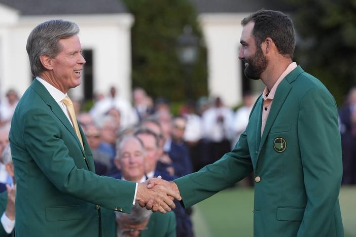 Fred Ridley, chairman of Augusta National Golf Club, shakes hands with Winner Scottie Scheffler at the Masters golf tournament at Augusta National Golf Club Sunday, April 14, 2024, in Augusta, Ga. 