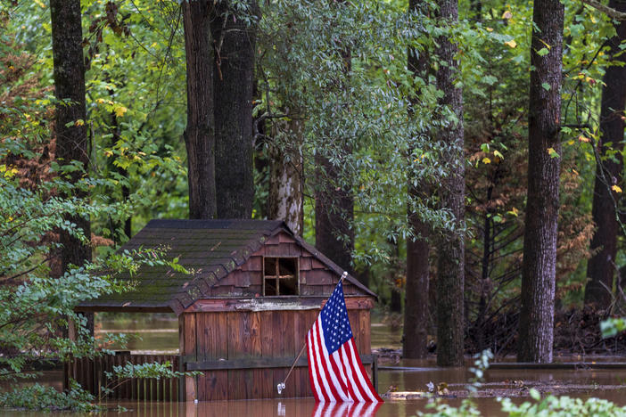 Floodwaters surround a structure Friday, Sept 27, 2024, in Atlanta. 