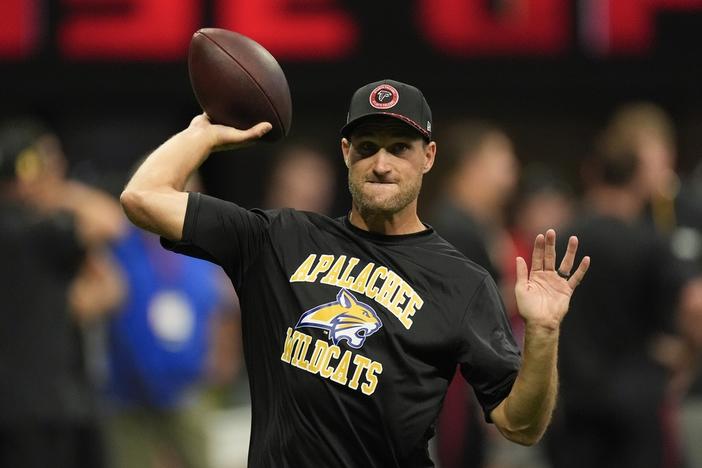 Atlanta Falcons quarterback Kirk Cousins warms up, while wearing an Apalachee High School T-shirt following a recent school shooting there, before an NFL football game against the Pittsburgh Steelers on Sunday, Sept. 8, 2024, in Atlanta. 