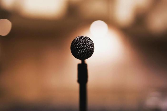 A stock photo of a microphone against a blurred background