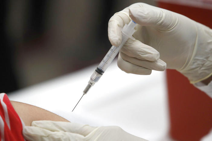 In this Thursday, Jan. 23, 2020, file photo, a patient receives an influenza vaccine in Mesquite, Texas. Amid all the focus on COVID-19 vaccinations, U.S. health experts have another plea: Don’t skip your flu shot. With U.S. schools and businesses reopened, international travel resuming and far less masking this fall, flu is likely to make a comeback. 