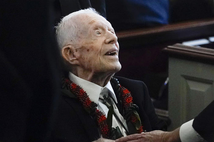 Former President Jimmy Carter greets attendees as he departs the funeral service for his wife, former first lady Rosalynn Carter, at Maranatha Baptist Church in Plains, Ga., Nov. 29, 2023. 