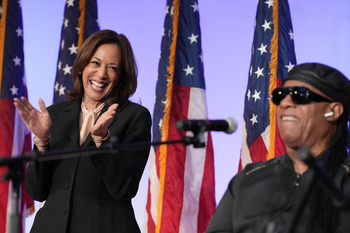 Democratic presidential nominee Vice President Kamala Harris listens as Stevie Wonder performs "Redemption Song" during a church service and early vote event at Divine Faith Ministries International, Sunday, Oct. 20, 2024, in Jonesboro, Ga. 