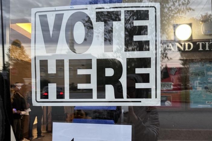 A sign directs voters to the entrance of the Cobb County Government Services Center in Marietta, Ga., on Oct. 15, 2024.