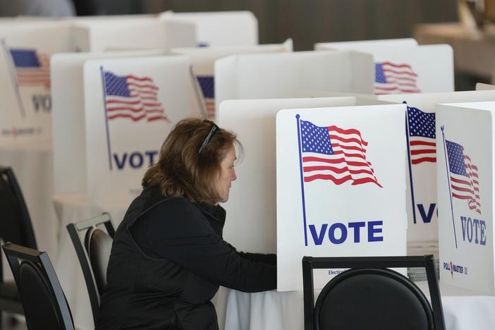 A voter fills out her ballot for the Michigan primary election in Grosse Pointe Farms, Mich., Tuesday, Feb. 27, 2024. 