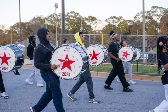 The Jonesboro High Majestic Marching Cardinals play their instruments during their final band practice before heading off to the Macy's Thanksgiving Day Parade.