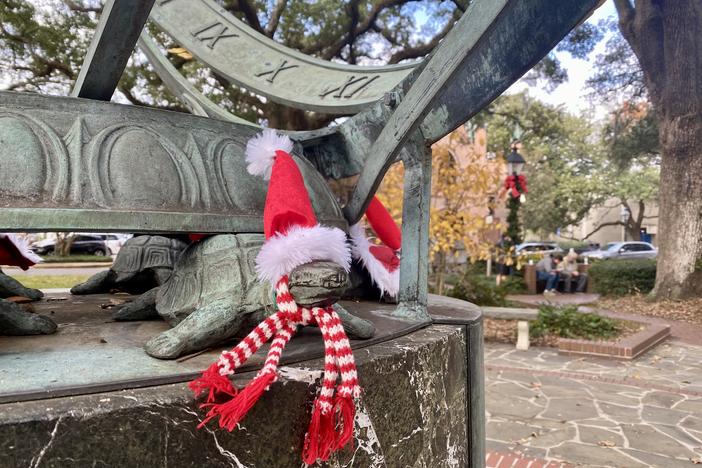 During Christmastime, the turtle sculptures in downtown Savannah's Troup Square are dressed in Santa Claus hats.