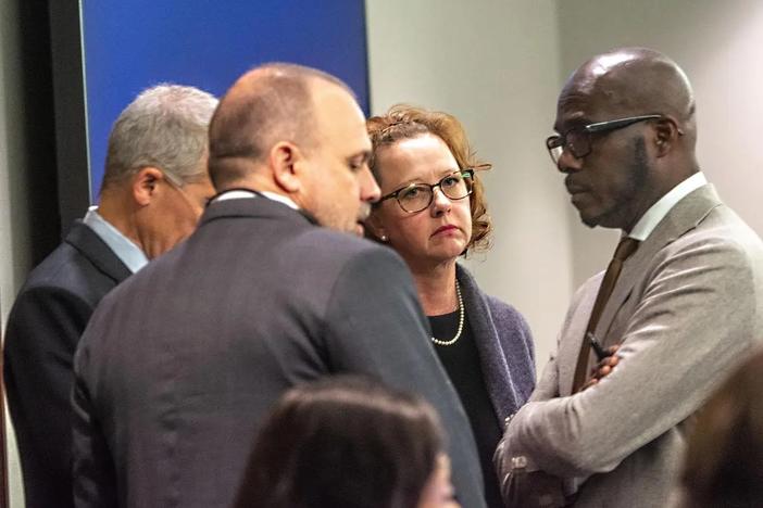 Former Brunswick Judicial Circuit District Attorney Jackie Johnson, second from right, speaks to her legal team Tuesday at the Glynn County Courthouse in Brunswick that includes Brian Steel, left, Jason Clark, second from left, and Keith Adams, right. Tuesday was the first day of jury selection in Johnson’s trial on charges of obstruction and violation of oath of office. (Michael Hall/Brunswick News)