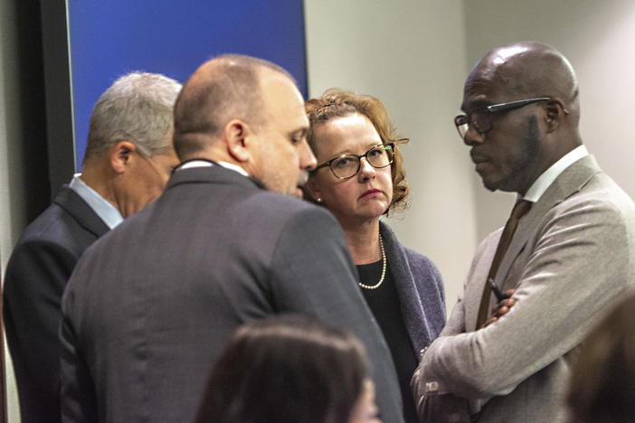 Former District Attorney Jackie Johnson, second from right, stands with her defense attorneys in court Tuesday, Jan. 21, 2025, in Brunswick, Georgia, as jury selection begins in her trial on misconduct charges. Johnson is charged with interfering with police investigating the 2020 killing of Ahmaud Arbery.