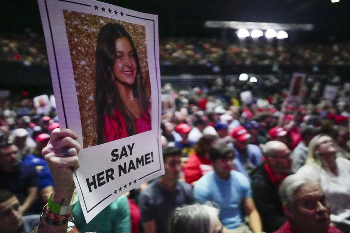 A supporter holds a poster with a photo of Laken Riley before Republican presidential candidate former President Donald Trump speaks at a campaign rally March 9, 2024, in Rome Ga. 