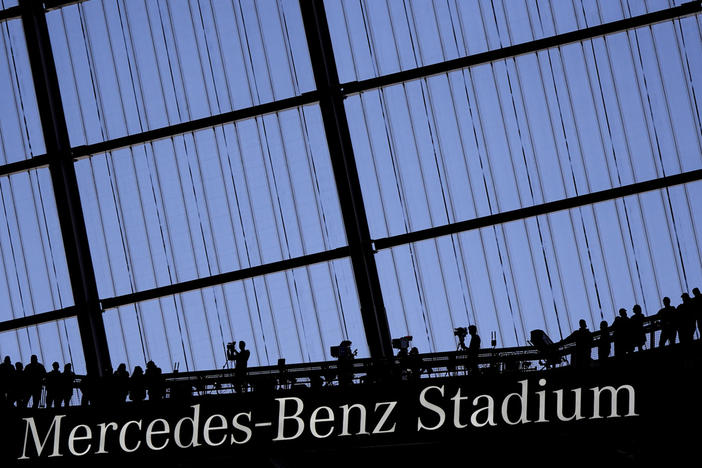 Fans watch an NFL football game at the Mercedes-Benz Stadium in Atlanta, Dec. 1, 2024.