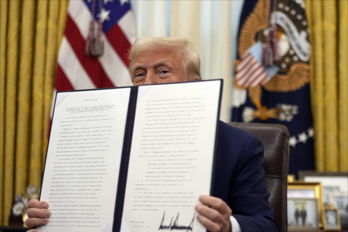 President Donald Trump holds a signed an executive order regarding the declassification and release of records relating to the assassinations of former President John F. Kennedy, Sen. Robert F. Kennedy and Rev. Martin Luther King, Jr., in the Oval Office of the White House, Thursday, Jan. 23, 2025, in Washington. 