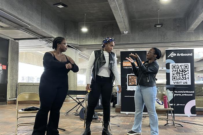 Zora Umeadi, Shakirah Demesier, and Asha Basha Duniadi perform a scene together for commuters at the College Park MARTA station on February 6, 2025.