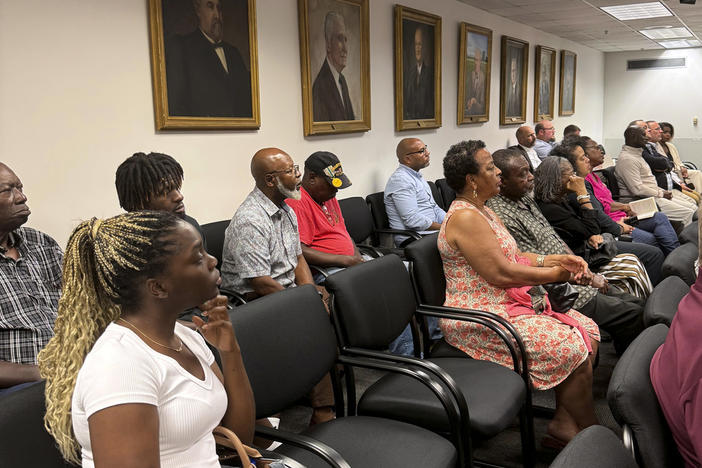 Sparta residents attend a Georgia Public Service Commission hearing on whether a railroad company can use eminent domain to condemn property in their community, in Atlanta, Aug. 6, 2024. 