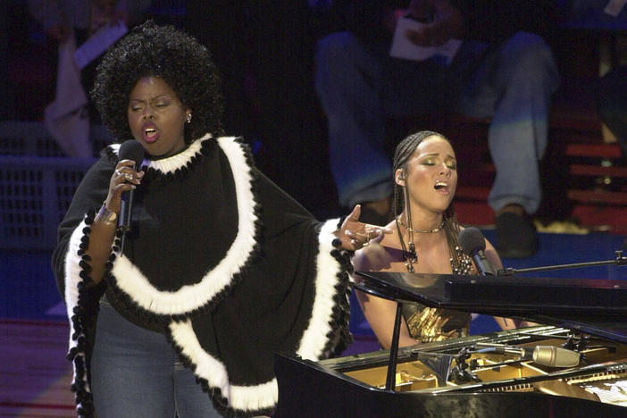 Alicia Keys, right, and Angie Stone, perform "America the Beautiful" during the NBA All-Star game in Philadelphia, Feb. 10, 2002. 