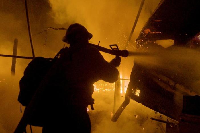 A firefighter putting out a fire.