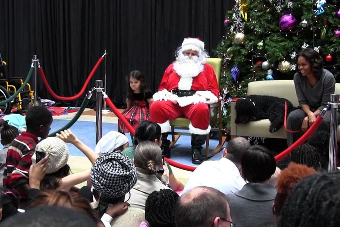 First Lady Michelle Obama tells children about her Christmas gift to the President.