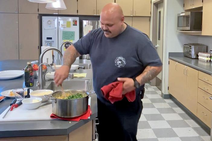Lidia oversees a California firefighter as he prepares her recipe Chicken alla Pitocca.