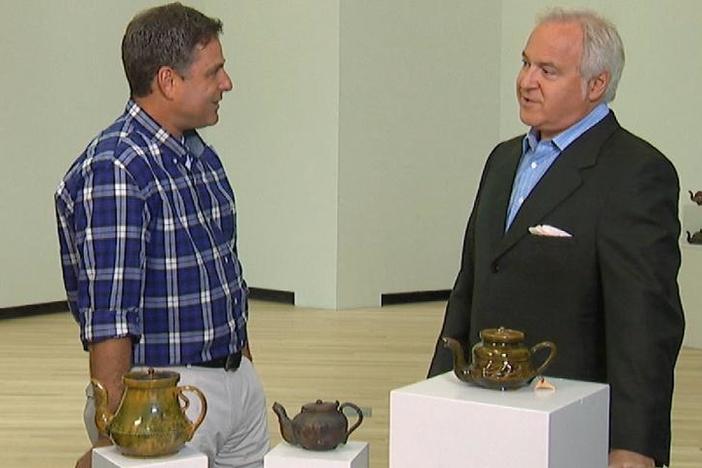 David Rago inspects the iconic artistry of George Ohr's tea pots.
