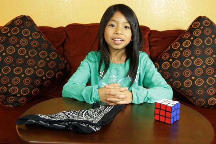 Watch Mya [unofficially] break the world record for solving a Rubik's cube, blind-folded!