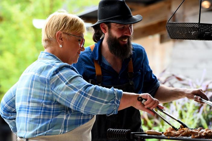 Ironbound Head Chef, Gunnar Bentley, shows Lidia how to cook on the 'mother fire'.