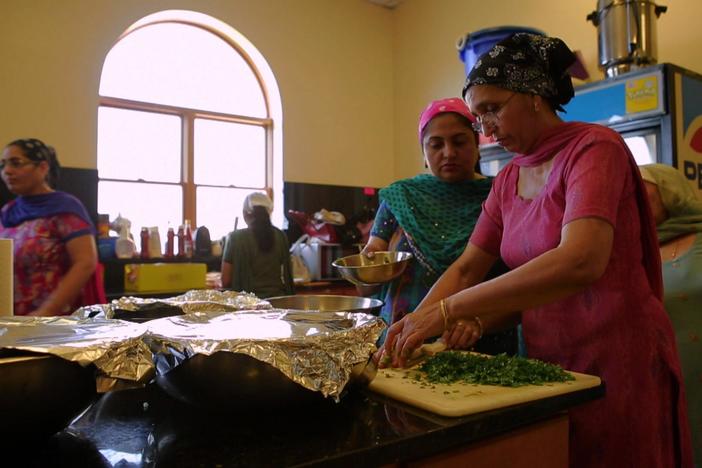 Women from a Sikh temple prepare for langar, a communal meal that is integral to the faith