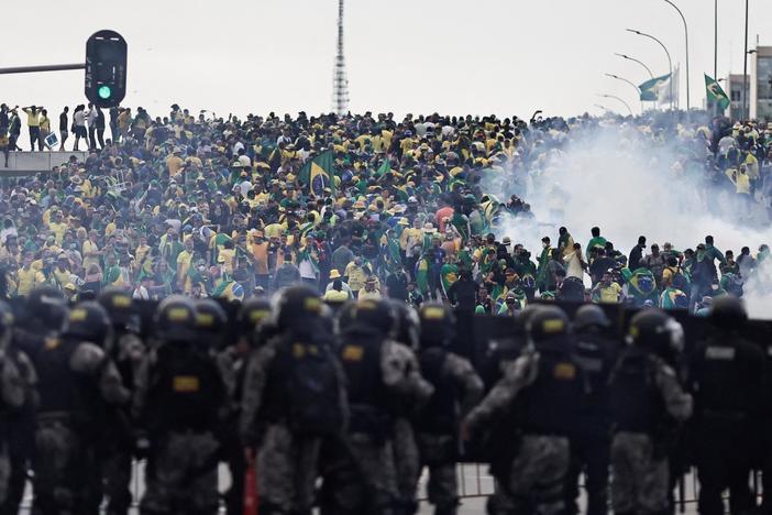 Supporters of defeated far-right president storm government buildings in Brazil