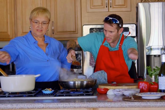 Army veteran, Bryan Anderson, and Lidia Bastianich cook a shrimp pasta meal together.