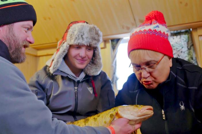 In Walker, MN, Lidia and her grandson Miles catch an eelpout...and kiss it for good luck!