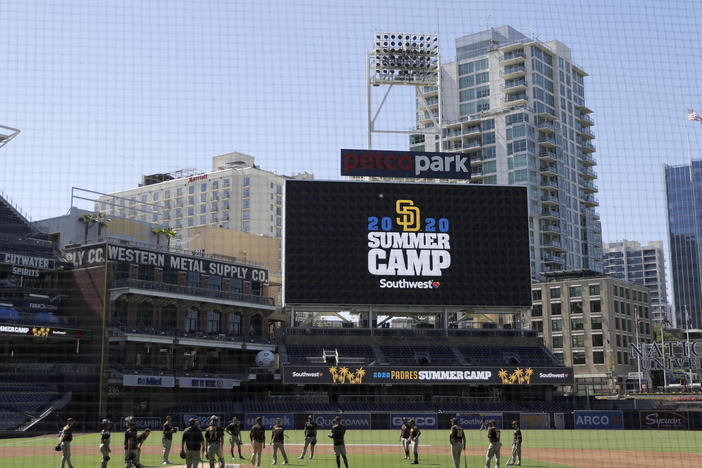 Members of the San Diego Padres meet in the infield during baseball training last week at Petco Park in San Diego. Major League Baseball is taking steps to start the 2020 season amid the coronavirus pandemic.