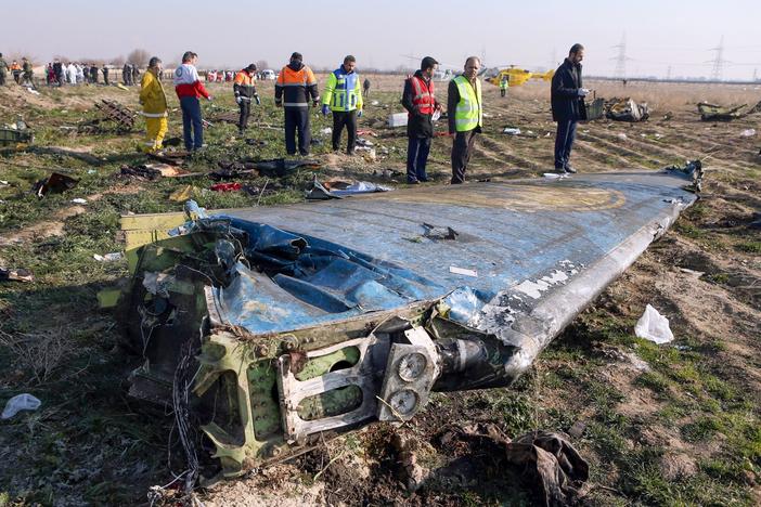 Rescue teams examine the wreckage of the Ukrainian airliner that was shot down shortly after takeoff in the Iranian capital, Tehran, on Jan. 8. Iran says a tragic series of mistakes led to the missile strike.